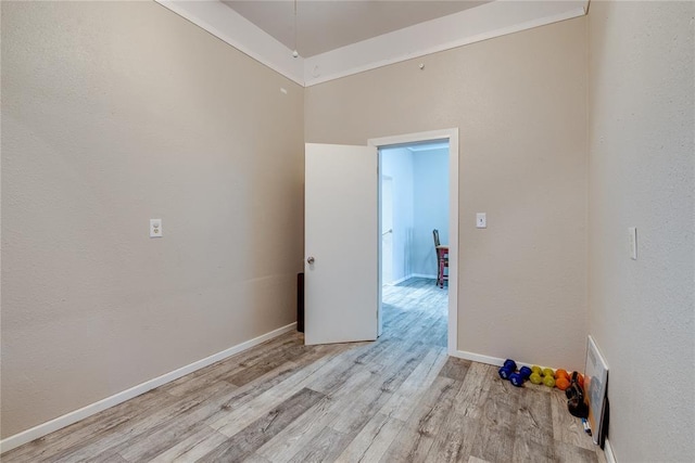 spare room featuring visible vents, light wood-style flooring, and baseboards