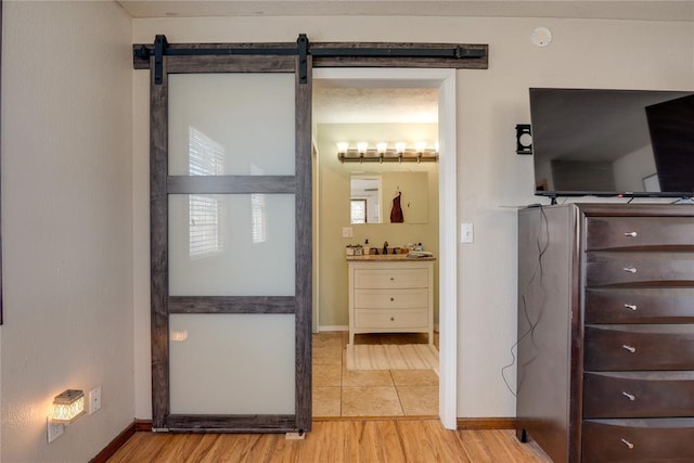 bathroom featuring vanity, baseboards, and wood finished floors