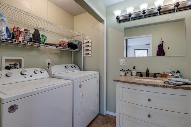 clothes washing area with laundry area, light tile patterned flooring, a sink, and separate washer and dryer