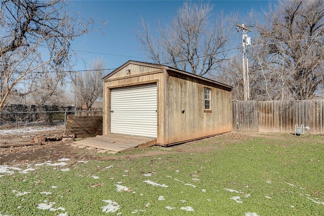 view of outdoor structure featuring an outbuilding and fence