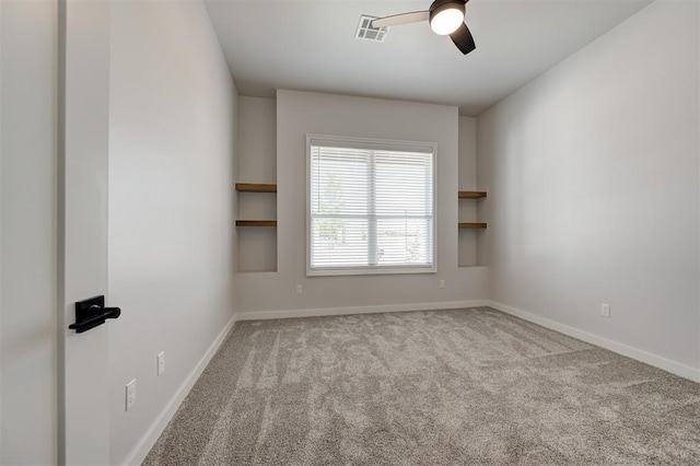 spare room featuring ceiling fan, carpet flooring, and baseboards