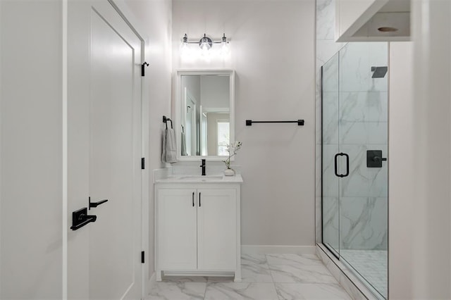 bathroom featuring marble look tiles, a marble finish shower, vanity, and baseboards