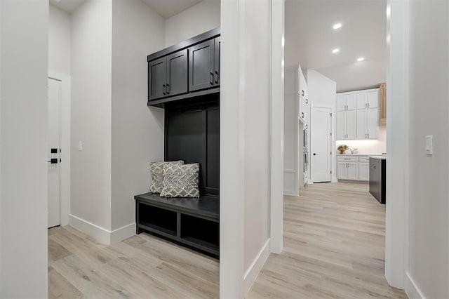 mudroom with light wood-type flooring and baseboards