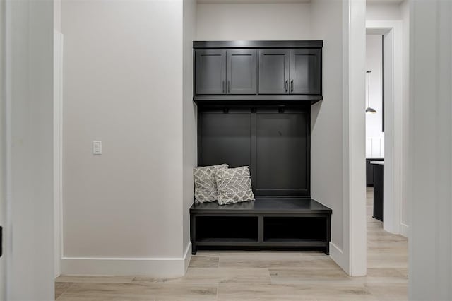 mudroom featuring baseboards and light wood-style floors
