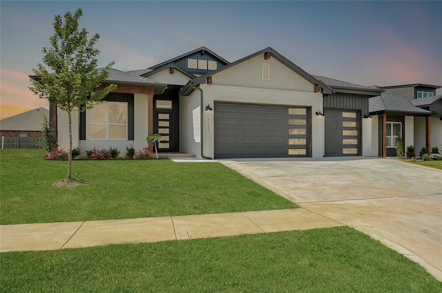 7112 NW 154th St, Edmond, OK 73013 - view of front of home with an attached garage, driveway, a front lawn, and stucco siding