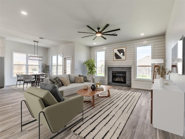 7112 NW 154th St, Edmond, OK 73013 - living room featuring a glass covered fireplace, light wood-style flooring, plenty of natural light, a ceiling fan, and recessed lighting