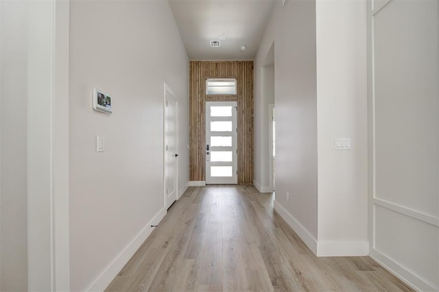 7112 NW 154th St, Edmond, OK 73013 - doorway to outside featuring light wood-style flooring and baseboards