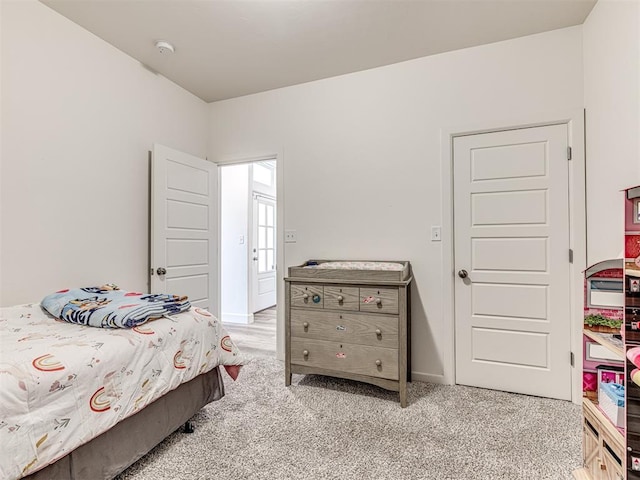 bedroom featuring light colored carpet