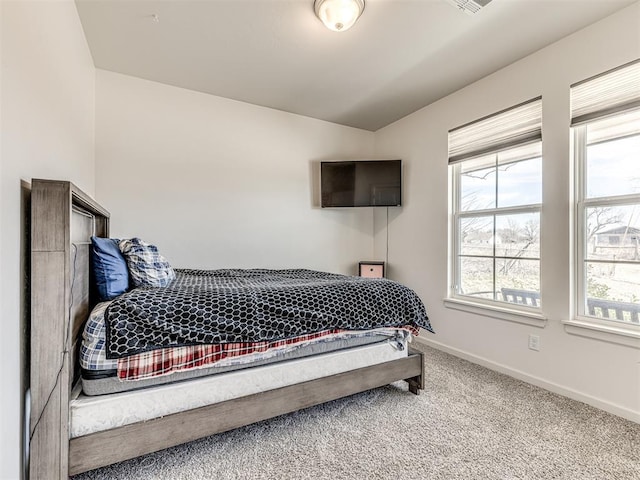 bedroom featuring carpet floors and baseboards