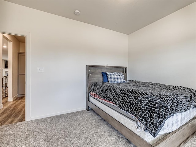 bedroom featuring carpet floors and baseboards