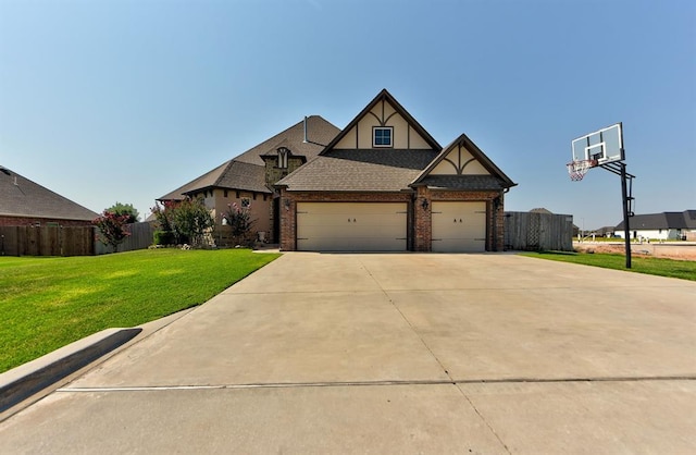 view of front of home featuring brick siding, an attached garage, fence, driveway, and a front lawn