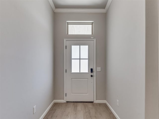 doorway to outside featuring light wood-type flooring, baseboards, and crown molding