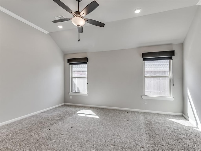 carpeted spare room featuring baseboards, visible vents, a ceiling fan, vaulted ceiling, and recessed lighting