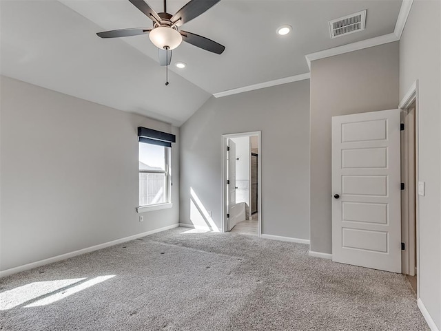 unfurnished bedroom featuring lofted ceiling, light carpet, visible vents, and baseboards