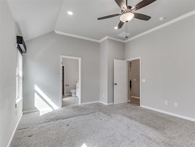 unfurnished bedroom with connected bathroom, light colored carpet, baseboards, vaulted ceiling, and crown molding