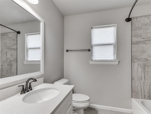 full bath featuring baseboards, shower / bathing tub combination, vanity, and toilet