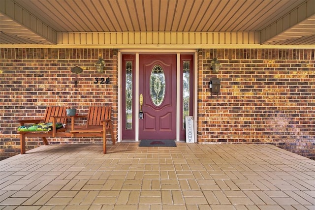 property entrance with brick siding