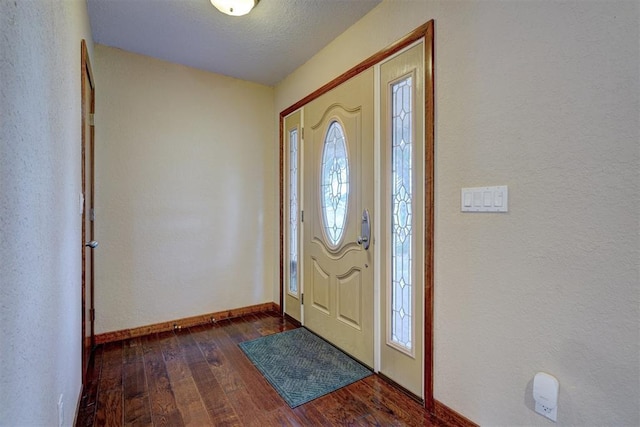 entryway with plenty of natural light, dark wood finished floors, and baseboards