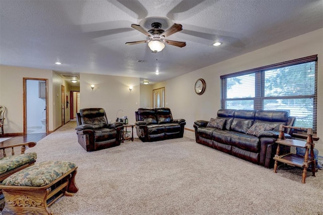 living room featuring carpet floors, recessed lighting, ceiling fan, a textured ceiling, and baseboards