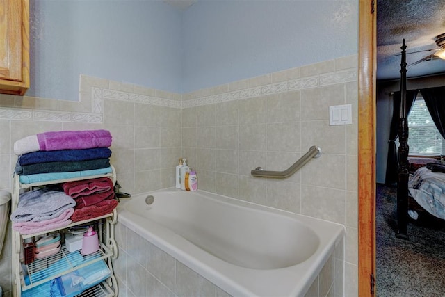 bathroom featuring a garden tub, tile walls, and ensuite bath