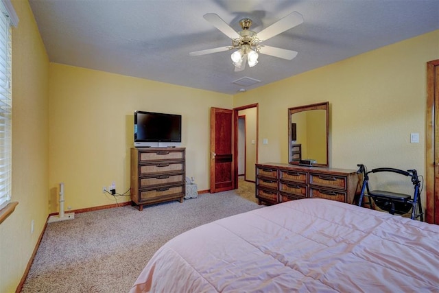 bedroom with ceiling fan, carpet flooring, and baseboards