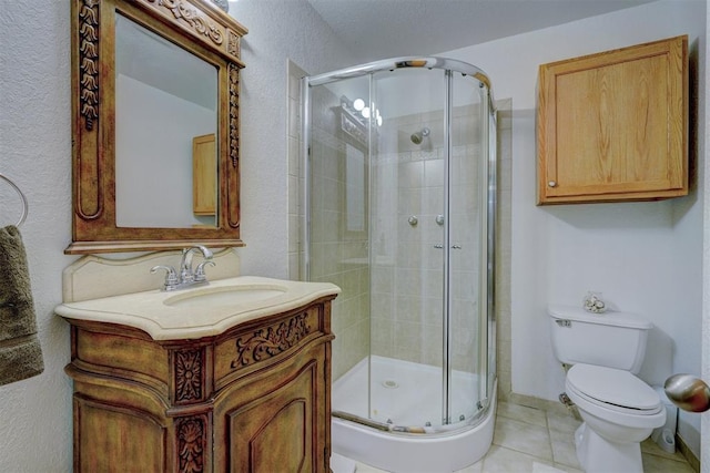 bathroom featuring toilet, a shower stall, tile patterned flooring, and vanity