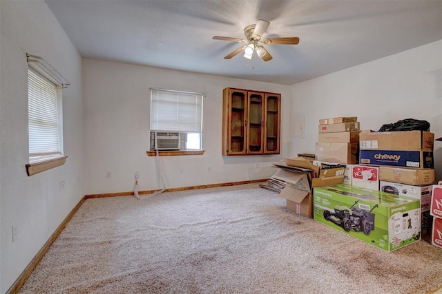 interior space featuring carpet, plenty of natural light, baseboards, and ceiling fan