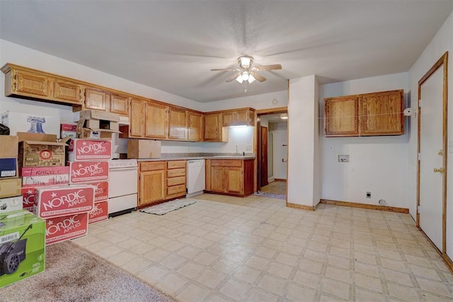 kitchen featuring light floors, white dishwasher, stove, and light countertops