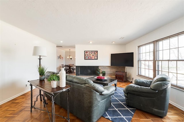 living area with recessed lighting, a textured ceiling, and baseboards