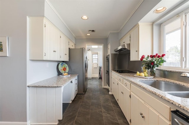 kitchen featuring visible vents, ornamental molding, under cabinet range hood, black appliances, and a sink