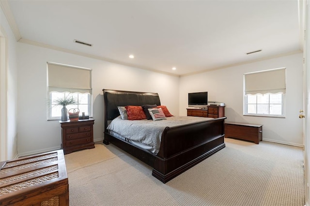 bedroom with multiple windows, visible vents, and crown molding