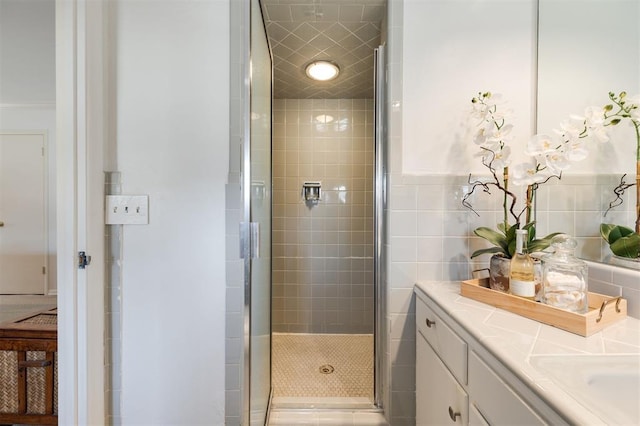 bathroom with a stall shower and vanity