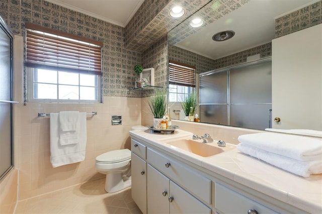 full bathroom featuring toilet, a wealth of natural light, tile walls, and vanity