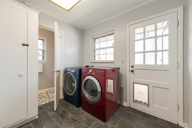 laundry room featuring baseboards, laundry area, washing machine and clothes dryer, and crown molding