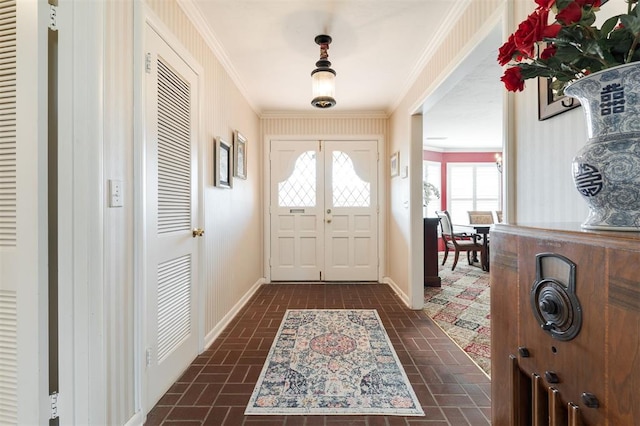 entryway with brick floor, baseboards, and crown molding