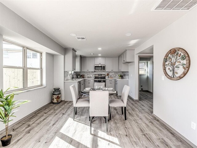 dining area with visible vents and light wood finished floors