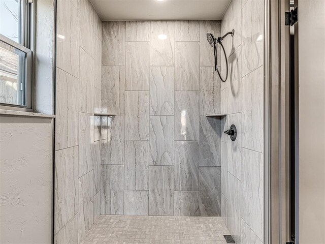 full bathroom with tiled shower