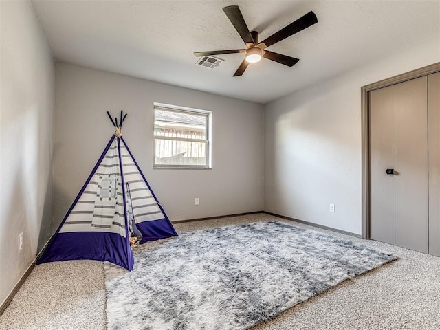 rec room with baseboards, carpet, visible vents, and a ceiling fan