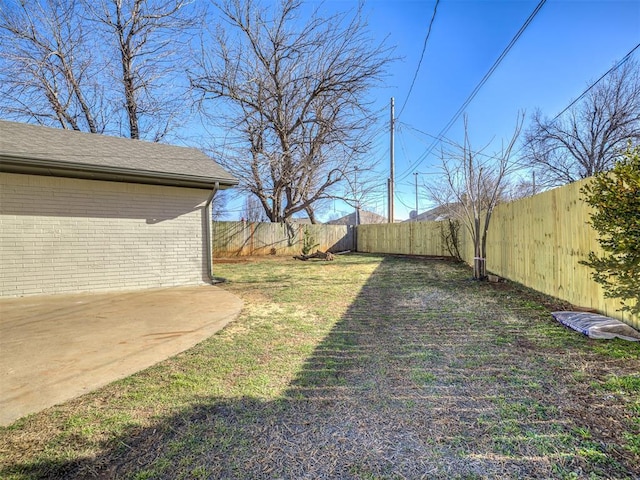 view of yard with a fenced backyard and a patio