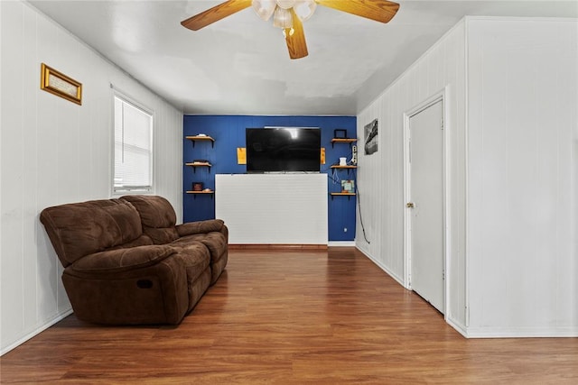 living area featuring ceiling fan and wood finished floors