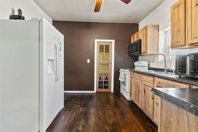 kitchen featuring dark wood-style flooring, dark countertops, light brown cabinetry, a sink, and white appliances