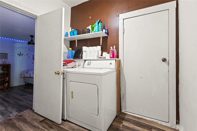 laundry area with laundry area, separate washer and dryer, and dark wood-style flooring