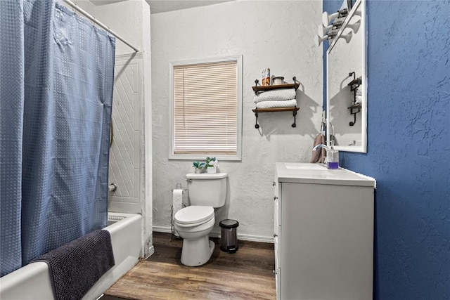 full bathroom with a textured wall, toilet, shower / tub combo, vanity, and wood finished floors