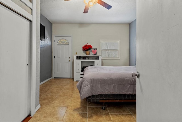 bedroom featuring a textured ceiling and ceiling fan