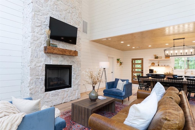 living area featuring wooden ceiling, plenty of natural light, and wood finished floors