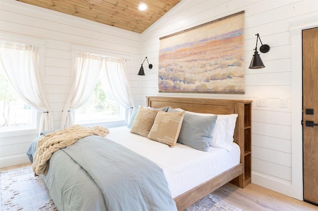 bedroom featuring lofted ceiling, wood walls, wood ceiling, and wood finished floors