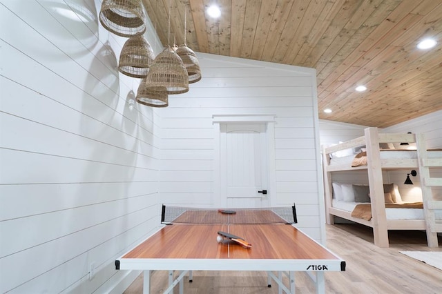 bedroom featuring wooden walls, wooden ceiling, wood finished floors, and recessed lighting