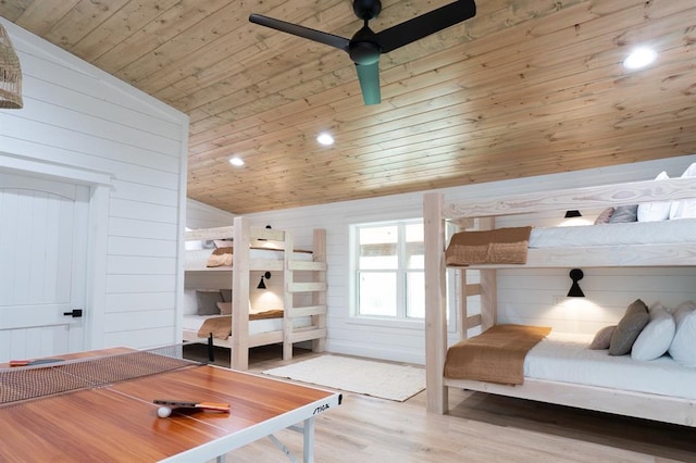 bedroom featuring recessed lighting, wood ceiling, wood walls, and wood finished floors