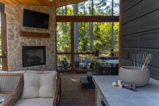 sunroom / solarium with a stone fireplace