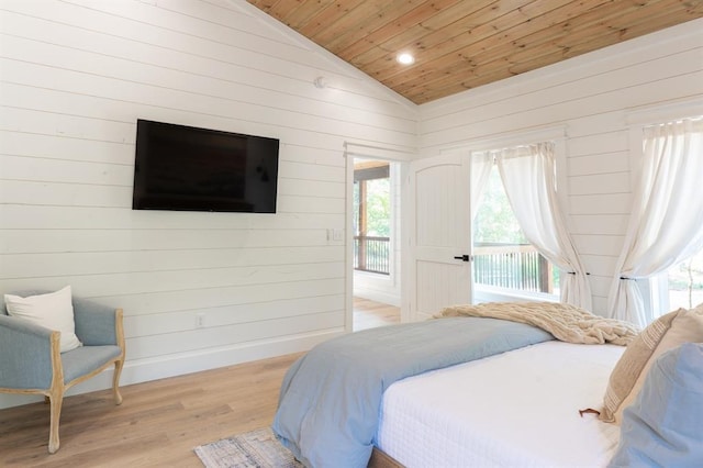 bedroom with access to exterior, lofted ceiling, wood finished floors, wooden ceiling, and baseboards